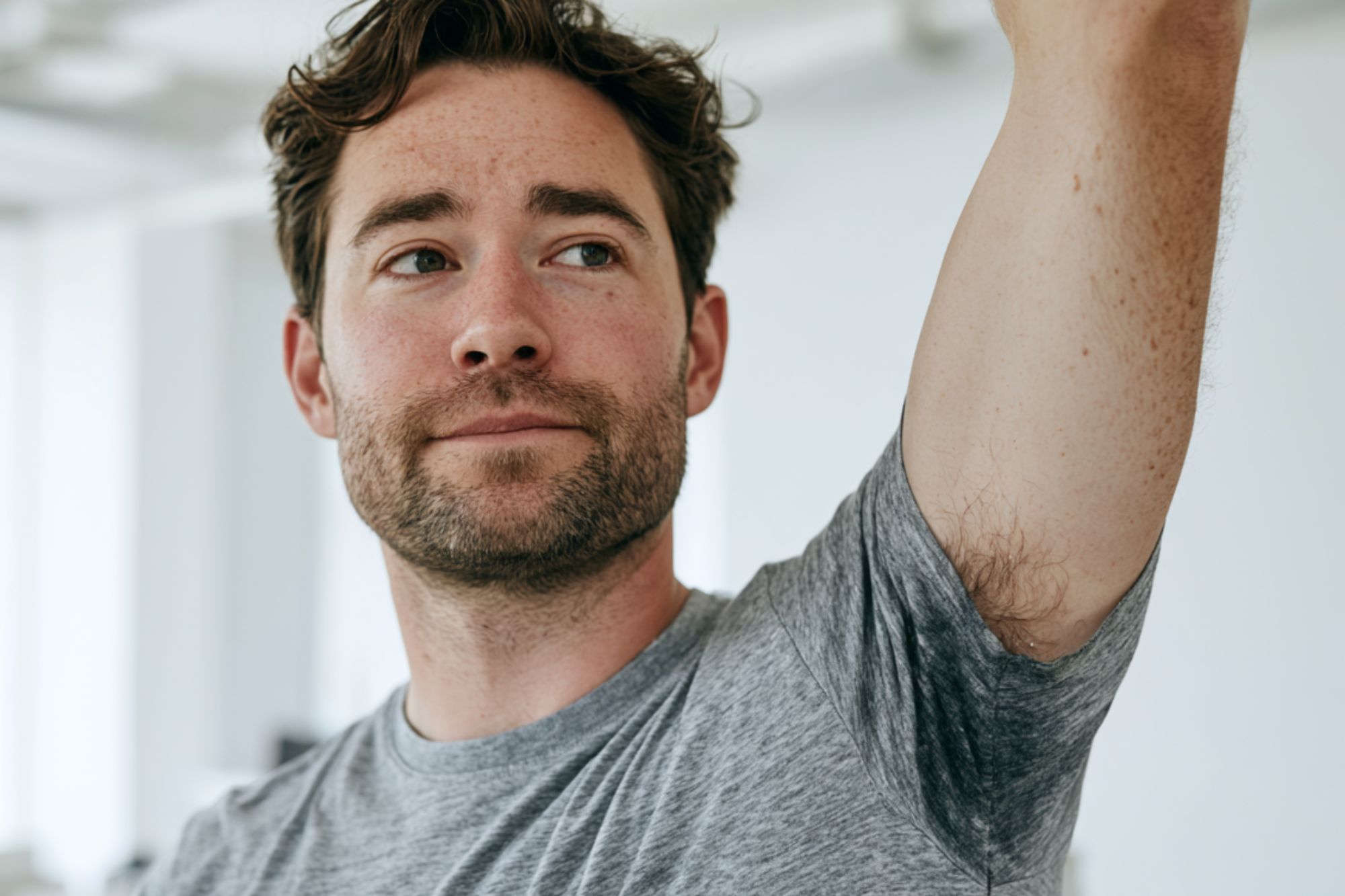 hyperhidrosis treatment online doctor consultation Man experiencing excessive underarm sweating alongside hyperhidrosis treatment products and a team of dermatology specialists offering online care